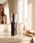 Couture Hair Pro cordless automatic hair curler standing on a marble bathroom vanity